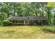 Charming brick ranch-style home with a well-maintained lawn and lush landscaping, offering serene curb appeal at 102 Forest Ct, Huntersville, NC 28078