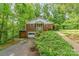 Charming front exterior of a brick home surrounded by mature trees and lush greenery at 102 Forest Ct, Huntersville, NC 28078