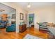 Hallway featuring hardwood floors and views into multiple rooms, providing a glimpse of the home's layout and design at 102 Forest Ct, Huntersville, NC 28078