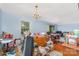 Living area with light blue walls, a vintage chandelier, and abundant natural light, full of clutter at 102 Forest Ct, Huntersville, NC 28078