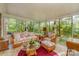 Bright sunroom surrounded by large windows and scenic views at 102 Forest Ct, Huntersville, NC 28078