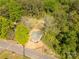 A cozy home with a green roof is surrounded by verdant trees and natural beauty from above at 119 Washington St, York, SC 29745
