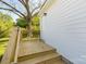 Newly constructed back porch with a wood rail and steps leading down to the yard at 119 Washington St, York, SC 29745