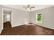 Bright bedroom with hardwood floors, a ceiling fan, and a view of the outdoors at 119 Washington St, York, SC 29745
