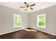 Bedroom with two windows, a ceiling fan and hardwood floors at 119 Washington St, York, SC 29745