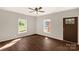 Spacious bedroom with two windows, a ceiling fan, and a dark wood-look floor at 119 Washington St, York, SC 29745