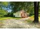 A charming home with a brick facade, and a large yard, shaded by mature trees at 119 Washington St, York, SC 29745