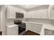 Bright kitchen boasts white cabinets, modern appliances, and ample counter space at 119 Washington St, York, SC 29745