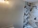 Bathroom features white marble-look tile in the shower and tub area at 122 39Th Avenue Nw Ct, Hickory, NC 28601