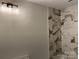 Bathroom boasting decorative lighting, marble tiled shower, and neutral paint at 122 39Th Avenue Nw Ct, Hickory, NC 28601