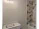 Bathroom with updated vanity, new lighting, and marble tiled shower at 122 39Th Avenue Nw Ct, Hickory, NC 28601