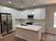 Kitchen with white cabinets, stainless steel appliances, a center island, and modern pendant lights at 122 39Th Avenue Nw Ct, Hickory, NC 28601