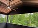 Covered porch featuring a ceiling fan and wooded views at 122 39Th Avenue Nw Ct, Hickory, NC 28601