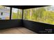 Covered patio with wooden flooring and views of lush greenery at 122 39Th Avenue Nw Ct, Hickory, NC 28601