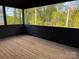 Spacious screened-in porch with wooden flooring, providing serene outdoor living at 122 39Th Avenue Nw Ct, Hickory, NC 28601