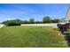 Spacious backyard featuring a well-maintained lawn, white picket fence, and space for outdoor activities and entertaining at 13012 Hunting Birds Ln, Charlotte, NC 28278
