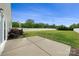 A large backyard with a concrete patio and white picket fence offers ample space for outdoor activities and relaxation at 13012 Hunting Birds Ln, Charlotte, NC 28278