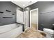 Stylish bathroom features a combined bathtub and shower, contemporary fixtures, and modern tiling at 13012 Hunting Birds Ln, Charlotte, NC 28278