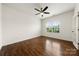 Bedroom featuring a ceiling fan, hardwood floors, and a window providing natural light at 13012 Hunting Birds Ln, Charlotte, NC 28278