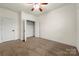 This bedroom features carpeted floors, a ceiling fan, and a closet at 13012 Hunting Birds Ln, Charlotte, NC 28278