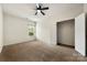 Bright bedroom features neutral carpet, ceiling fan, and a closet at 13012 Hunting Birds Ln, Charlotte, NC 28278