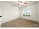 Bright bedroom features neutral carpet, ceiling fan, and a window that lets in natural light at 13012 Hunting Birds Ln, Charlotte, NC 28278