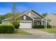 Charming home featuring a well-manicured lawn, two-car garage, and beautiful curb appeal at 13012 Hunting Birds Ln, Charlotte, NC 28278