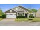 Charming single-story home with a two-car garage and well-manicured front yard at 13012 Hunting Birds Ln, Charlotte, NC 28278