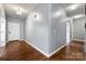 Hallway with hardwood floors, neutral paint, and recessed lighting connecting to various rooms at 13012 Hunting Birds Ln, Charlotte, NC 28278