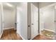 Hallway boasts sleek hardwood flooring and access to the laundry area at 13012 Hunting Birds Ln, Charlotte, NC 28278