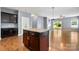 Kitchen island open to living room with hardwood floors and natural light at 13012 Hunting Birds Ln, Charlotte, NC 28278