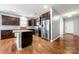 Modern kitchen with stainless steel appliances, dark cabinets, and granite countertops at 13012 Hunting Birds Ln, Charlotte, NC 28278