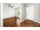 Bright living room features hardwood floors and a ceiling fan, leading to a bonus room at 13012 Hunting Birds Ln, Charlotte, NC 28278