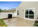 Cozy patio area with sliding glass doors, a grill, and white fence, perfect for outdoor dining and relaxation at 13012 Hunting Birds Ln, Charlotte, NC 28278