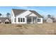 Back exterior showcasing screened porch and a spacious backyard with freshly laid sod at 13097 Arnold Palmer Cir # 844, Lancaster, SC 29720