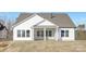 Back exterior showcasing screened porch and a spacious backyard with freshly laid sod at 13097 Arnold Palmer Cir # 844, Lancaster, SC 29720