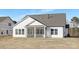 Back exterior showcasing screened porch and a spacious backyard with freshly laid sod at 13097 Arnold Palmer Cir # 844, Lancaster, SC 29720