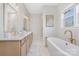 Elegant bathroom with a soaking tub, marble floors, and dual vanity sinks at 13097 Arnold Palmer Cir # 844, Lancaster, SC 29720