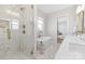 Luxurious bathroom featuring a glass-enclosed shower, soaking tub, and marble accents at 13097 Arnold Palmer Cir # 844, Lancaster, SC 29720