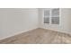 Bright bedroom featuring wood-look floors and a large window with natural light at 13097 Arnold Palmer Cir # 844, Lancaster, SC 29720