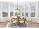 Bright dining area features a round wooden table, seating for four, and large windows with sheer white curtains at 13097 Arnold Palmer Cir # 844, Lancaster, SC 29720
