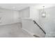 Well-lit hallway with neutral carpet, white trim, and staircase with wood handrail at 13097 Arnold Palmer Cir # 844, Lancaster, SC 29720