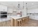 Bright kitchen with an island and bar stool seating, modern appliances, and white cabinetry at 13097 Arnold Palmer Cir # 844, Lancaster, SC 29720