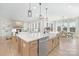 Open-concept kitchen and living room view featuring an island, fireplace, and a cozy seating area at 13097 Arnold Palmer Cir # 844, Lancaster, SC 29720