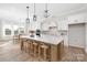 Bright, spacious kitchen with a large center island, modern pendant lighting, and an adjacent dining area at 13097 Arnold Palmer Cir # 844, Lancaster, SC 29720