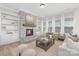 Cozy living room with stone fireplace, built-in shelving, and a rustic coffee table at 13097 Arnold Palmer Cir # 844, Lancaster, SC 29720