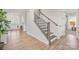 Elegant staircase featuring wooden steps and a sleek metal railing design at 13097 Arnold Palmer Cir # 844, Lancaster, SC 29720