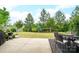 Relaxing backyard features a patio with outdoor seating, lush green lawn, and mature trees at 13103 Union Square Dr, Huntersville, NC 28078