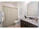 Cozy bathroom features granite vanity, shower with patterned curtain, and decorative mirror at 13103 Union Square Dr, Huntersville, NC 28078