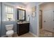 Stylish bathroom featuring a vanity with a granite countertop, a framed mirror, and modern fixtures at 13103 Union Square Dr, Huntersville, NC 28078